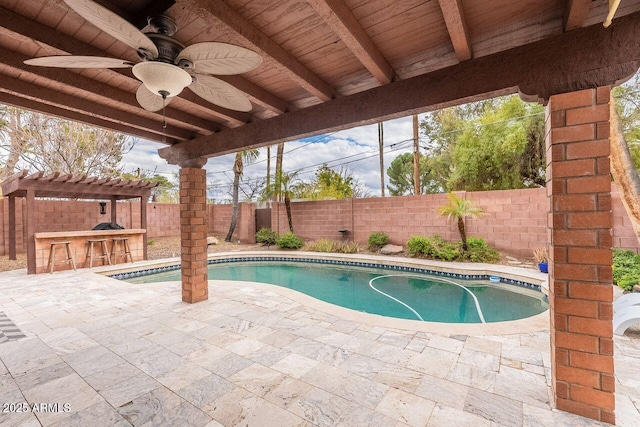 view of pool with outdoor dry bar, a fenced in pool, ceiling fan, a fenced backyard, and a patio