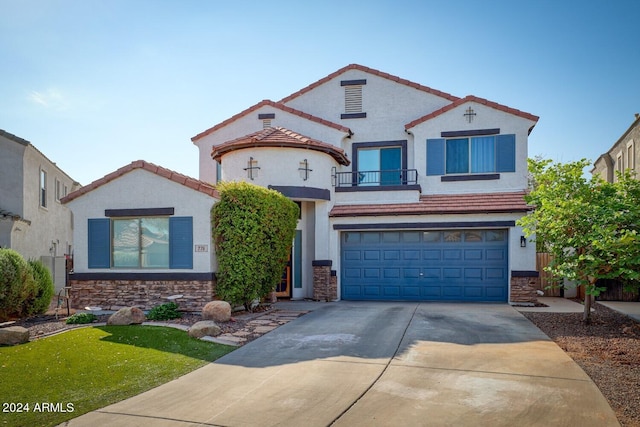 mediterranean / spanish-style house with a balcony, a garage, and a front lawn