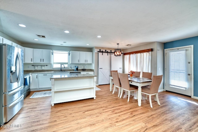 775 E Leslie Ave, San Tan Valley, AZ 85140 - kitchen with stainless steel refrigerator with ice dispenser, a sink, open shelves, a chandelier, and light wood-style flooring