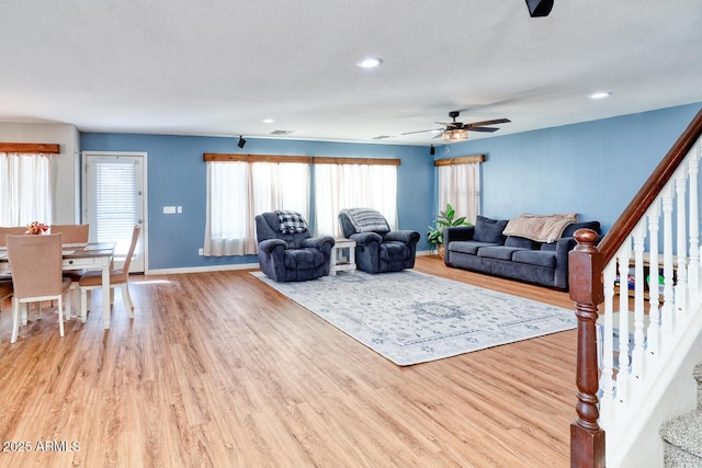 775 E Leslie Ave, San Tan Valley, AZ 85140 - living area featuring stairway, light wood-style flooring, a ceiling fan, recessed lighting, and plenty of natural light