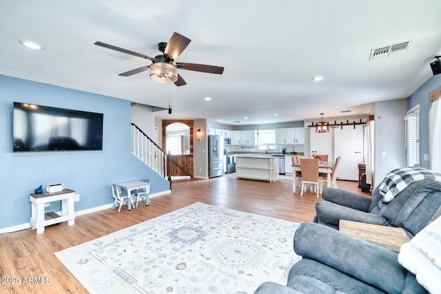 775 E Leslie Ave, San Tan Valley, AZ 85140 - living room featuring light wood-type flooring, a ceiling fan, stairway, recessed lighting, and baseboards