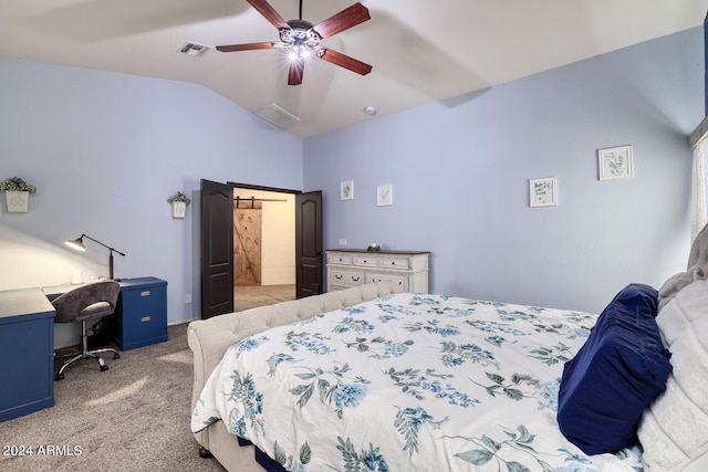 carpeted bedroom featuring vaulted ceiling, a barn door, and ceiling fan