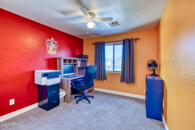 carpeted office with ceiling fan and a textured ceiling