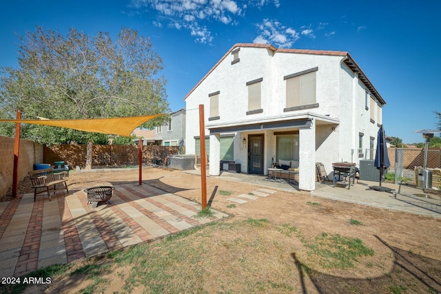 back of property featuring a patio area and an outdoor fire pit