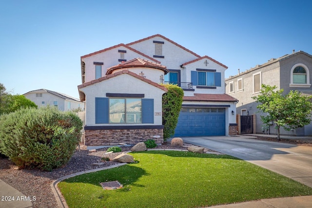 mediterranean / spanish-style house featuring a garage and a front yard