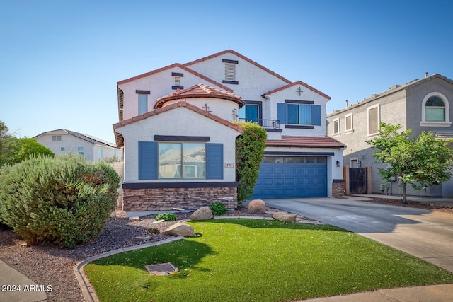 775 E Leslie Ave, San Tan Valley, AZ 85140 - mediterranean / spanish-style home with stone siding, a garage, concrete driveway, a front lawn, and stucco siding