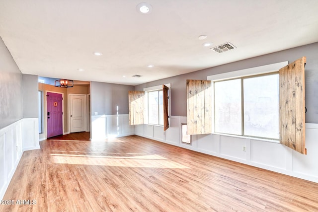 775 E Leslie Ave, San Tan Valley, AZ 85140 - unfurnished room with a decorative wall, wainscoting, wood finished floors, recessed lighting, and a chandelier