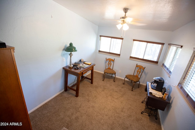 sitting room with light colored carpet, ceiling fan, and plenty of natural light