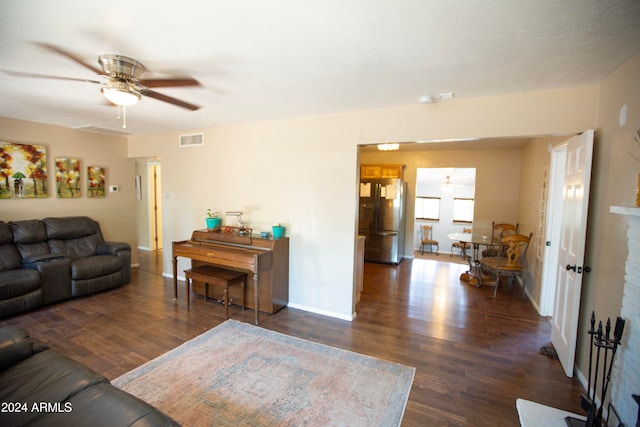 living room featuring dark hardwood / wood-style flooring and ceiling fan