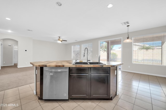 kitchen with a center island with sink, dishwasher, open floor plan, hanging light fixtures, and a sink