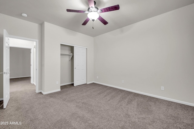 unfurnished bedroom with a closet, carpet flooring, a ceiling fan, and baseboards