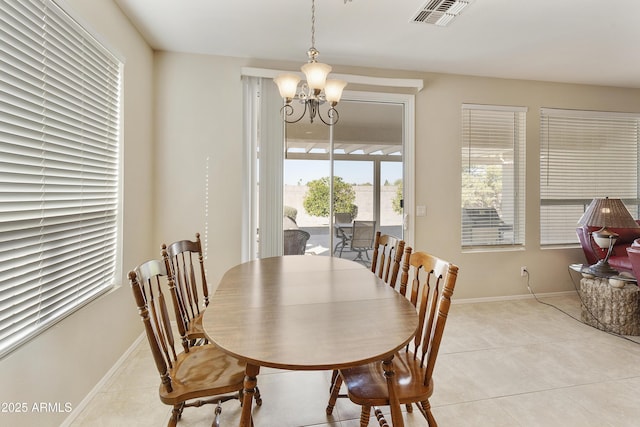 dining room featuring light tile patterned floors, baseboards, visible vents, and a chandelier