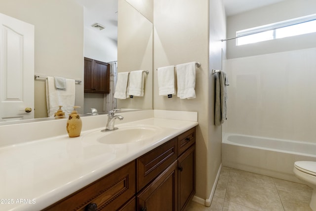 bathroom with toilet, vanity, baseboards, visible vents, and tile patterned floors