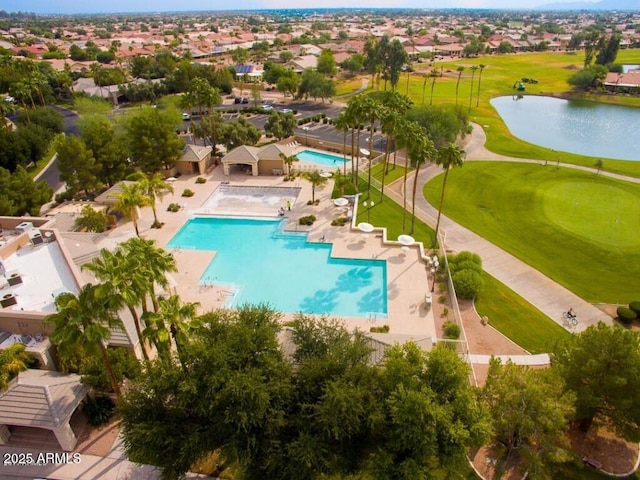 pool with view of golf course, a patio area, and a water view