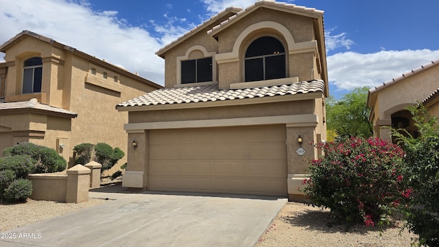 1909 N 106th Ave, Avondale, AZ 85392 - mediterranean / spanish house with concrete driveway, stucco siding, a tile roof, and a garage