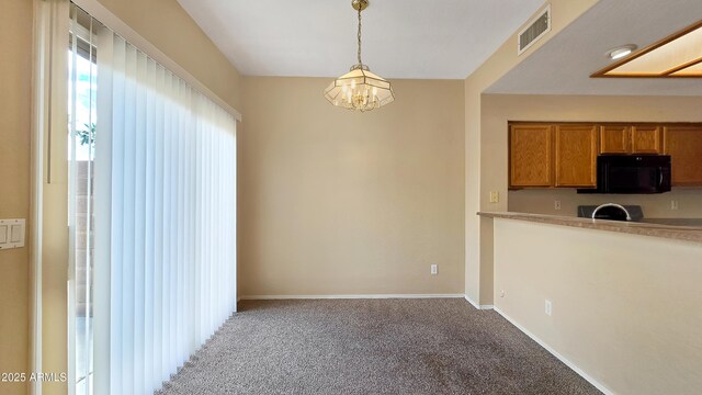 1909 N 106th Ave, Avondale, AZ 85392 - unfurnished dining area featuring a chandelier, carpet, visible vents, and baseboards