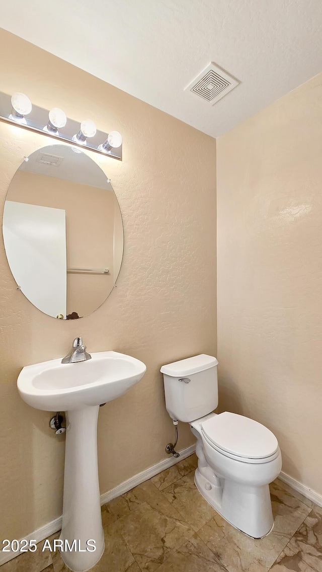 1909 N 106th Ave, Avondale, AZ 85392 - bathroom with visible vents, toilet, marble finish floor, and baseboards