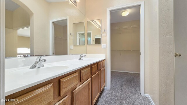 1909 N 106th Ave, Avondale, AZ 85392 - full bathroom with baseboards, double vanity, a sink, and a walk in closet