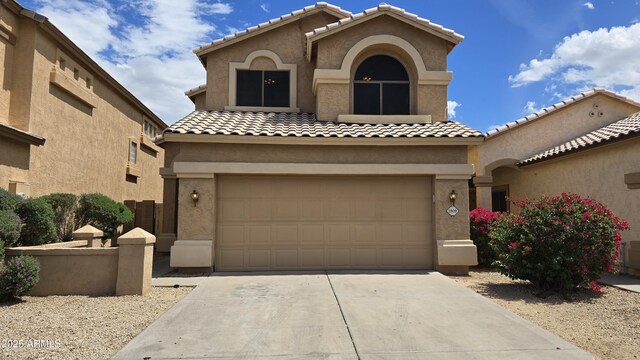 1909 N 106th Ave, Avondale, AZ 85392 - mediterranean / spanish-style home with driveway, stucco siding, and a tiled roof