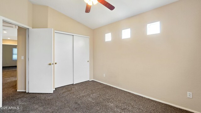 1909 N 106th Ave, Avondale, AZ 85392 - unfurnished bedroom with a closet, baseboards, vaulted ceiling, dark carpet, and ceiling fan