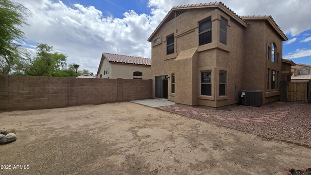 1909 N 106th Ave, Avondale, AZ 85392 - rear view of property with central AC, a fenced backyard, a tile roof, and stucco siding