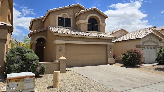 1909 N 106th Ave, Avondale, AZ 85392 - mediterranean / spanish-style home featuring a tiled roof, driveway, a garage, and stucco siding