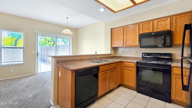 1909 N 106th Ave, Avondale, AZ 85392 - kitchen featuring brown cabinetry, a peninsula, black appliances, a chandelier, and a sink