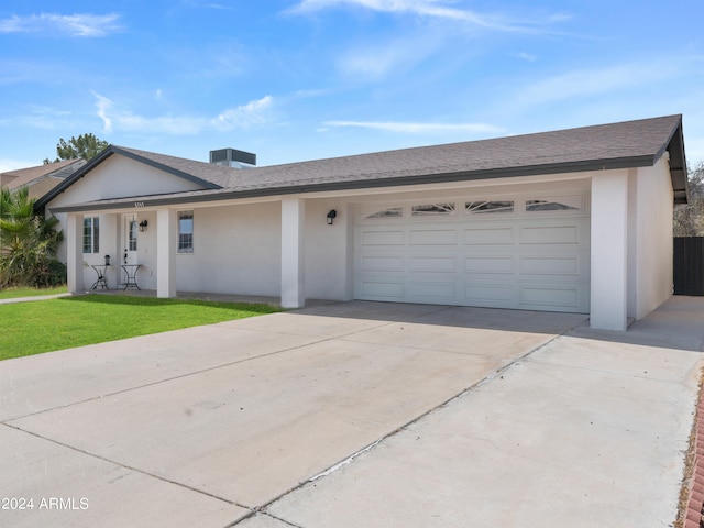 ranch-style home featuring a garage