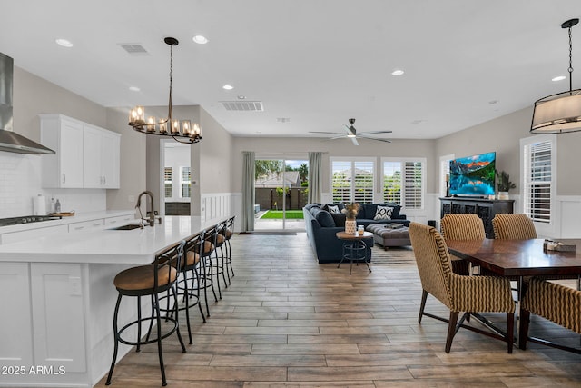 3915 N Shannon Cir, Mesa, AZ 85215 - dining space featuring light wood-type flooring, a chandelier, ceiling fan, recessed lighting, and wainscoting