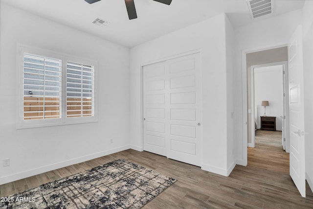 3915 N Shannon Cir, Mesa, AZ 85215 - unfurnished bedroom featuring wood finished floors, a closet, and a ceiling fan