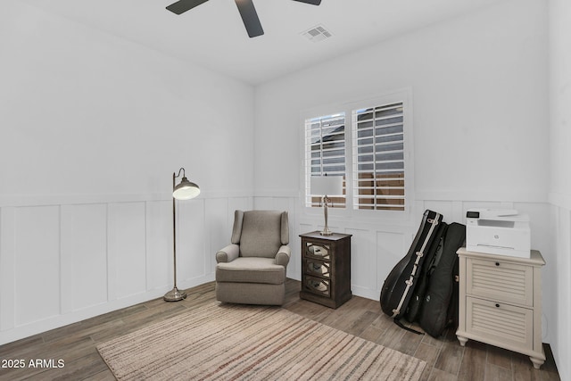3915 N Shannon Cir, Mesa, AZ 85215 - sitting room with ceiling fan, wood finished floors, a decorative wall, and a wainscoted wall