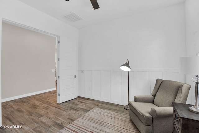 3915 N Shannon Cir, Mesa, AZ 85215 - living area with ceiling fan, wood finished floors, and a wainscoted wall