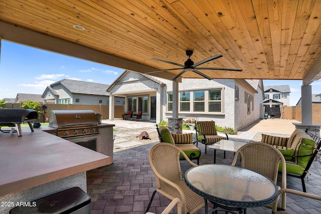 3915 N Shannon Cir, Mesa, AZ 85215 - fenced backyard featuring a patio, exterior kitchen, outdoor dining area, and a ceiling fan