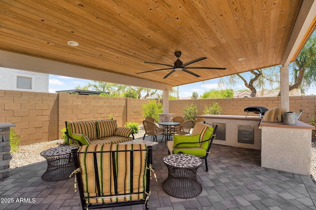 3915 N Shannon Cir, Mesa, AZ 85215 - fenced backyard featuring exterior kitchen, a patio area, outdoor dining area, an outdoor hangout area, and a ceiling fan
