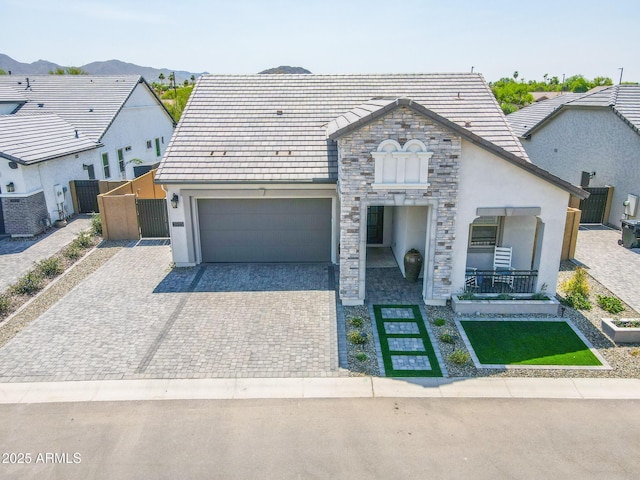 3915 N Shannon Cir, Mesa, AZ 85215 - french provincial home with stucco siding, stone siding, decorative driveway, a garage, and a mountain view