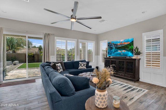 3915 N Shannon Cir, Mesa, AZ 85215 - living room featuring a ceiling fan, wood finished floors, a decorative wall, a wainscoted wall, and recessed lighting