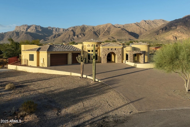 mediterranean / spanish home featuring a mountain view and a garage