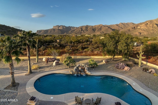 view of swimming pool featuring a mountain view, a patio, and pool water feature