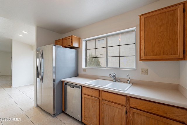 kitchen featuring appliances with stainless steel finishes, sink, and light tile patterned floors