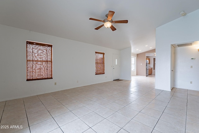 unfurnished room featuring lofted ceiling, light tile patterned floors, and ceiling fan