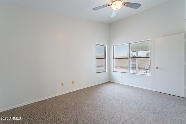 unfurnished room featuring ceiling fan and carpet