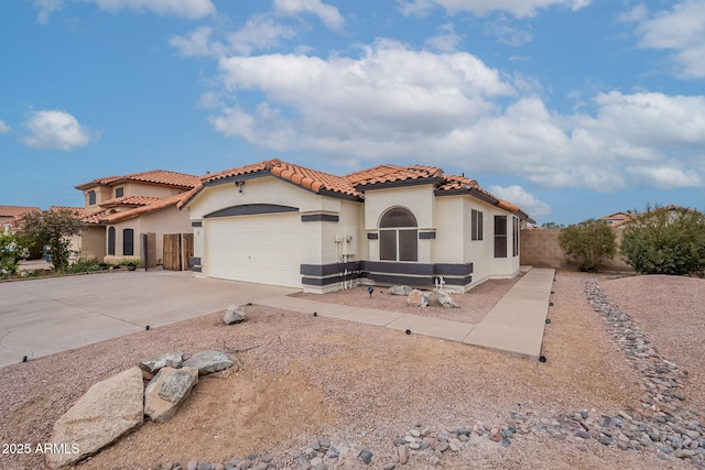 mediterranean / spanish home featuring a garage