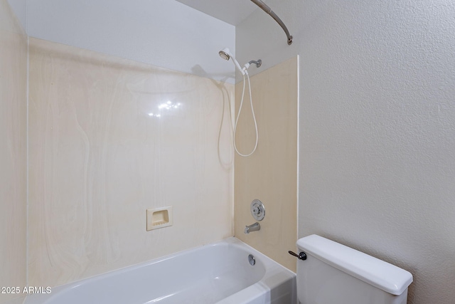 bathroom featuring shower / bathing tub combination and toilet