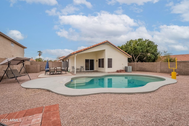 view of pool with cooling unit and a patio