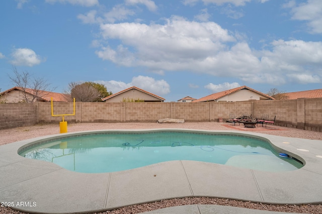 view of swimming pool with a fire pit and a patio area