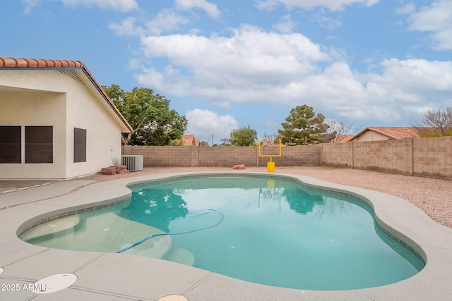 view of swimming pool featuring a patio and central air condition unit