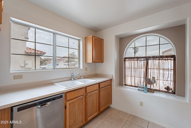 kitchen with dishwasher, sink, and light tile patterned floors