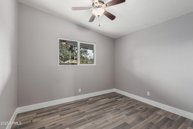 spare room featuring dark wood-type flooring, ceiling fan, and lofted ceiling