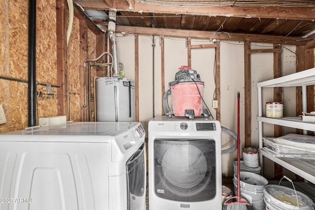 clothes washing area featuring water heater and washing machine and dryer