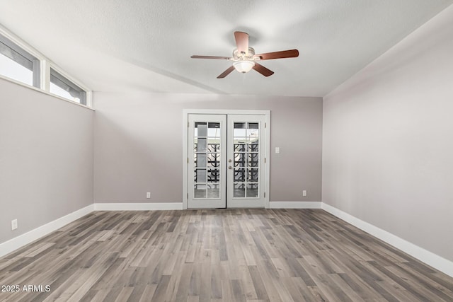 unfurnished room featuring hardwood / wood-style flooring, french doors, and a healthy amount of sunlight